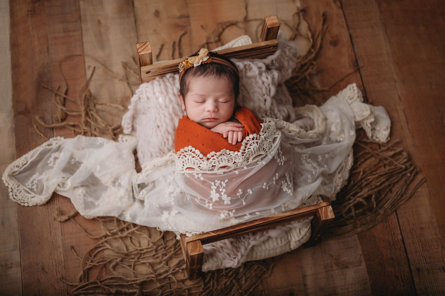 Tampa Newborn Photographer- Baby in bed with lace wrap
