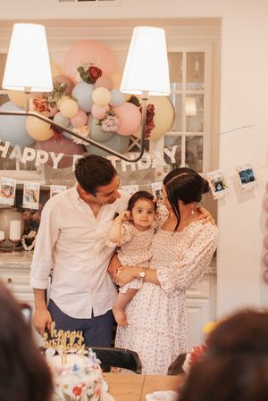 Intimate family birthday celebration with balloons and decorations.
