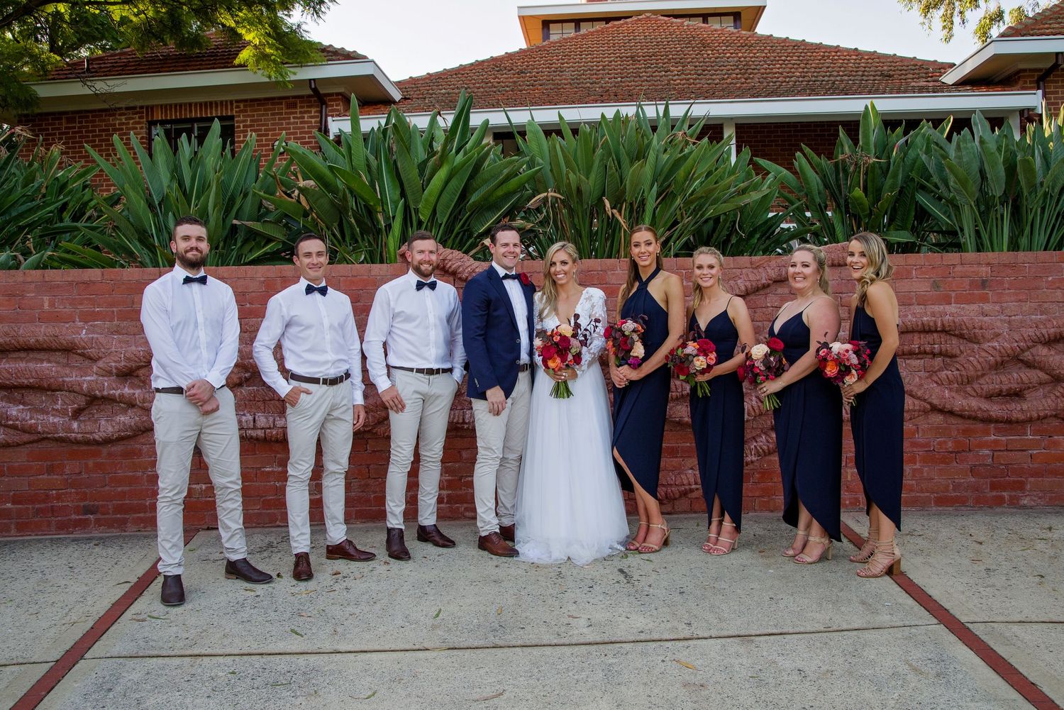 bridal party in a line smiling at camera at Heathcote Reserve Perth