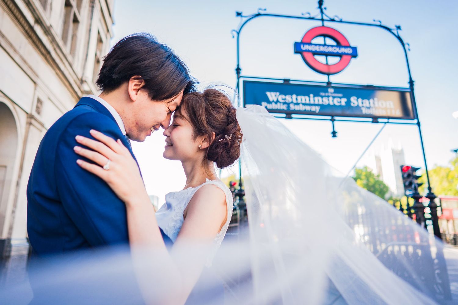Pre-wedding couple in London by iconic tube sign