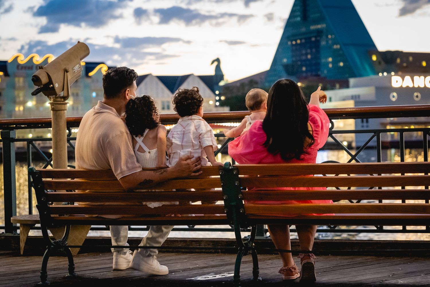 Family enjoying a sunset at Disney's Boardwalk hotel, creating beautiful memories together.
