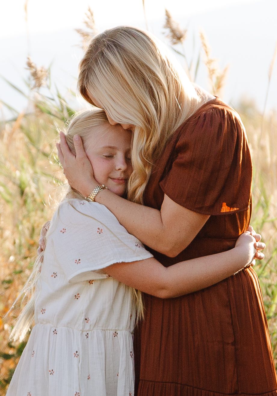 mother and daughter hugging in the fall at utah lake