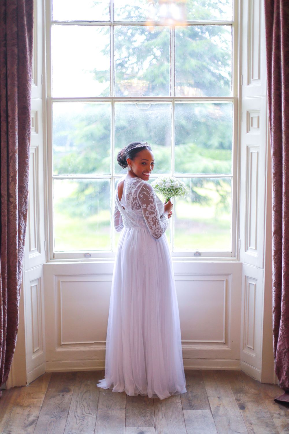 Bride posing in room at wedding venue