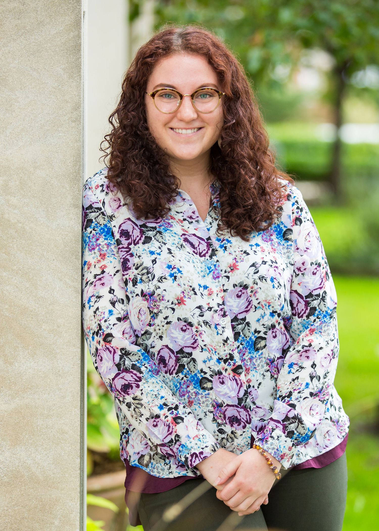 headshot woman leaning against wall