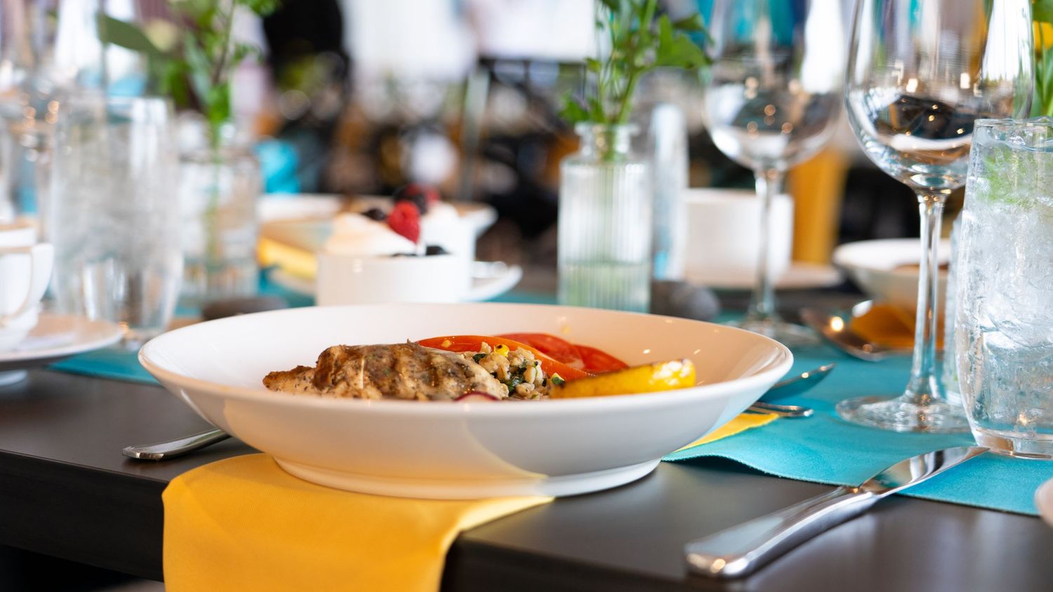 Plated gourmet dish served on white dinnerware with elegant table settings.