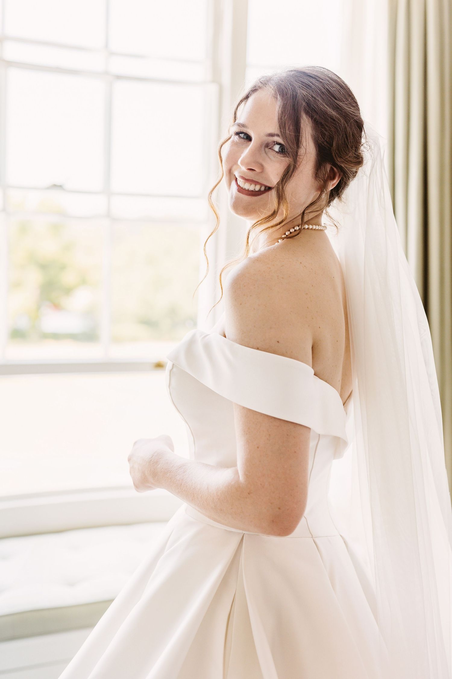 Beautiful bride wearing a stunning wedding dress ready for her ceremony at Remenham Court