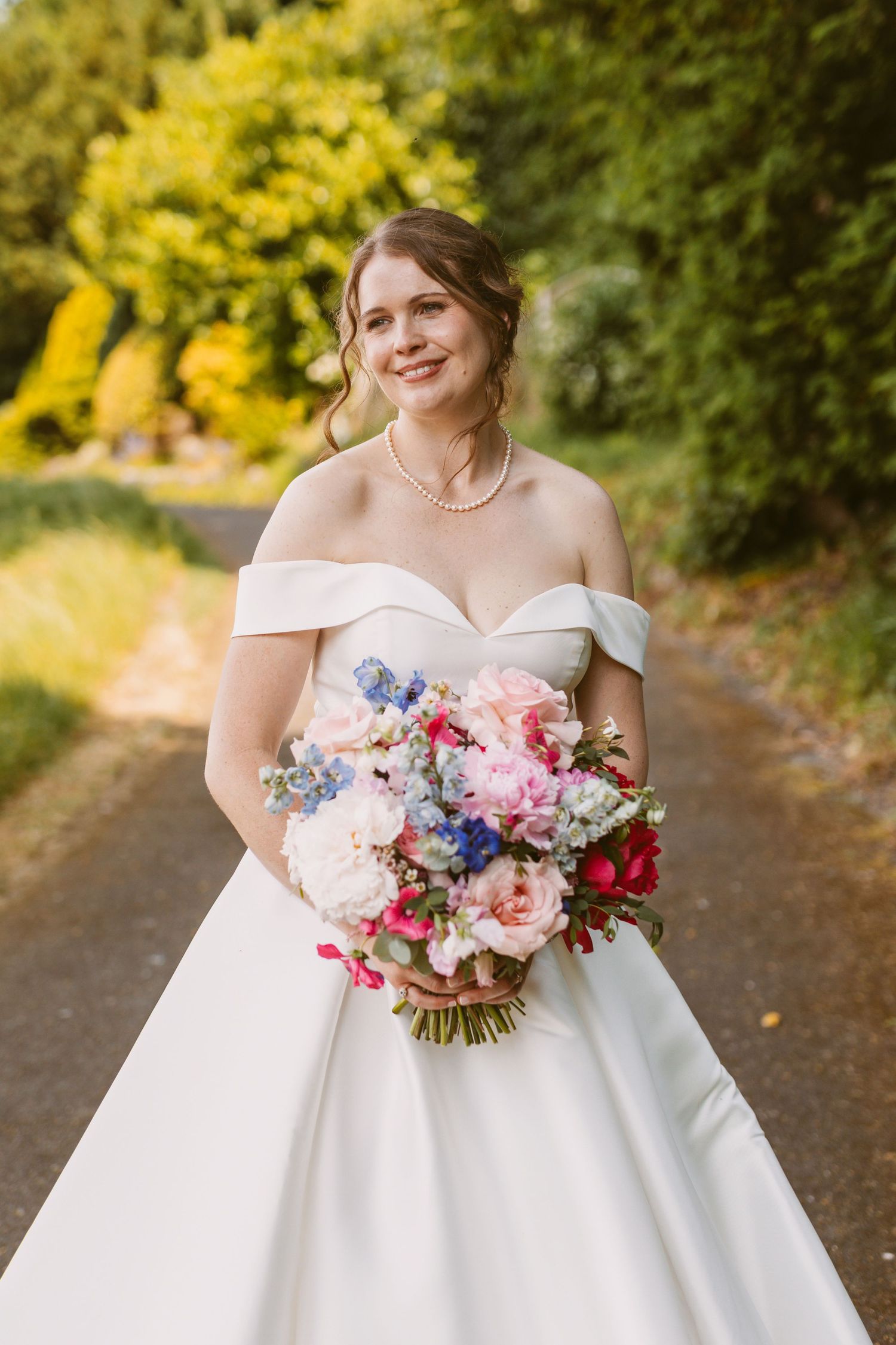 Relaxed beautiful young bride looking joyful and bursting with happiness on her wedding day