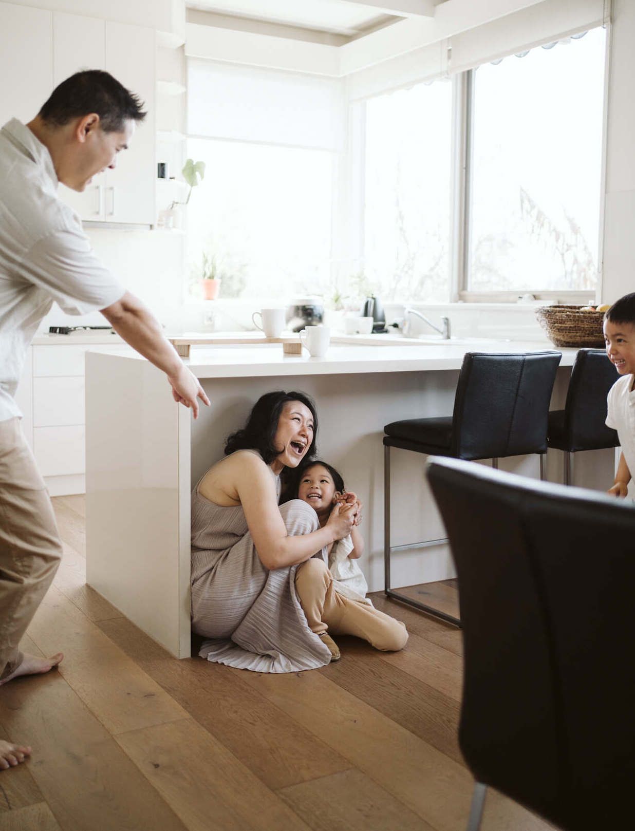 Family playing hide and seek game at home.