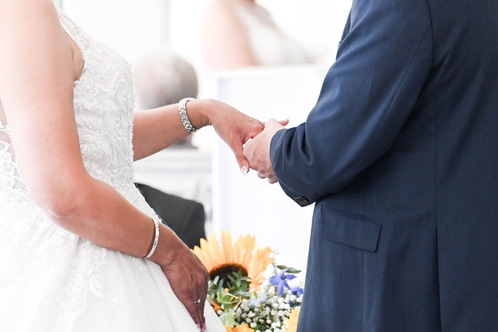 Elegant wedding details with navy and white color scheme in bright setting.