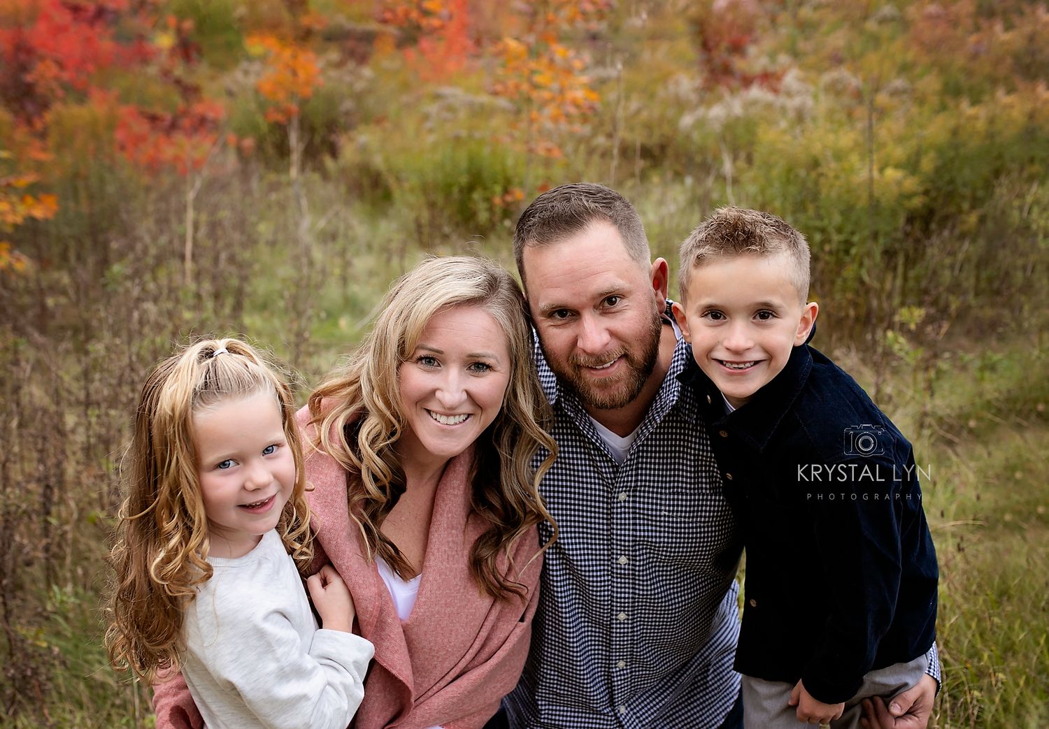 Close up family photo with bright bold colors and smiles from all