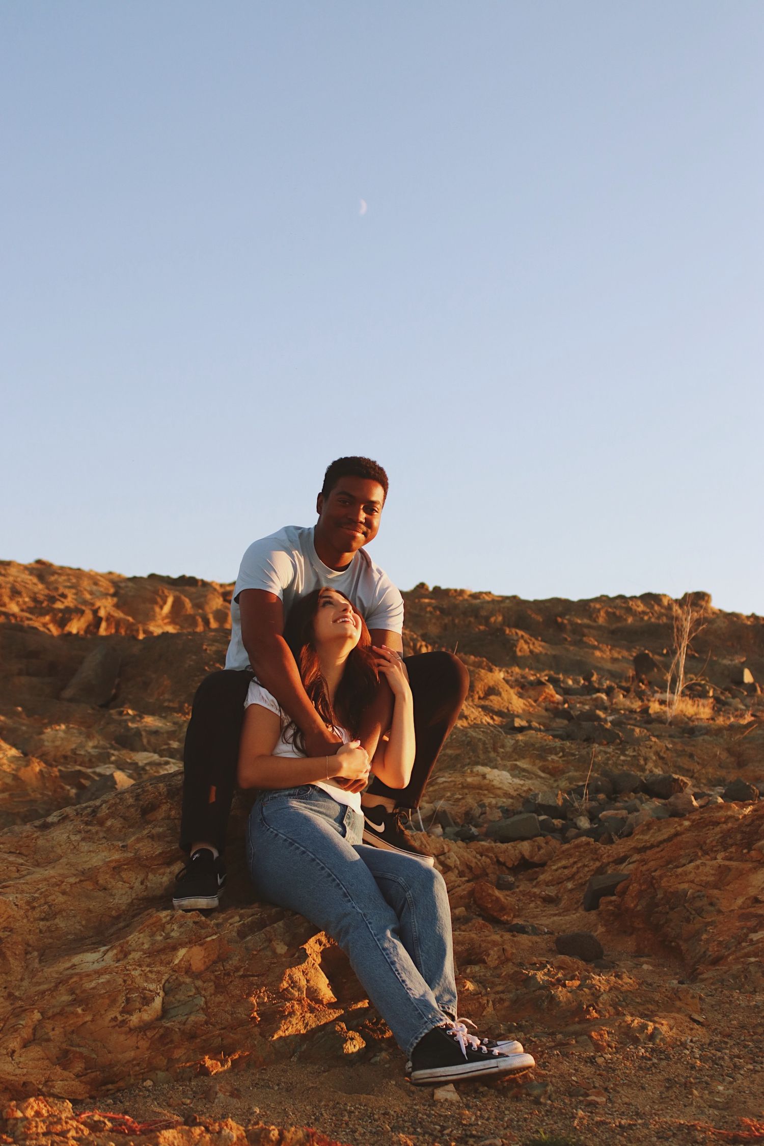 boy and girl cuddling in the desert sun