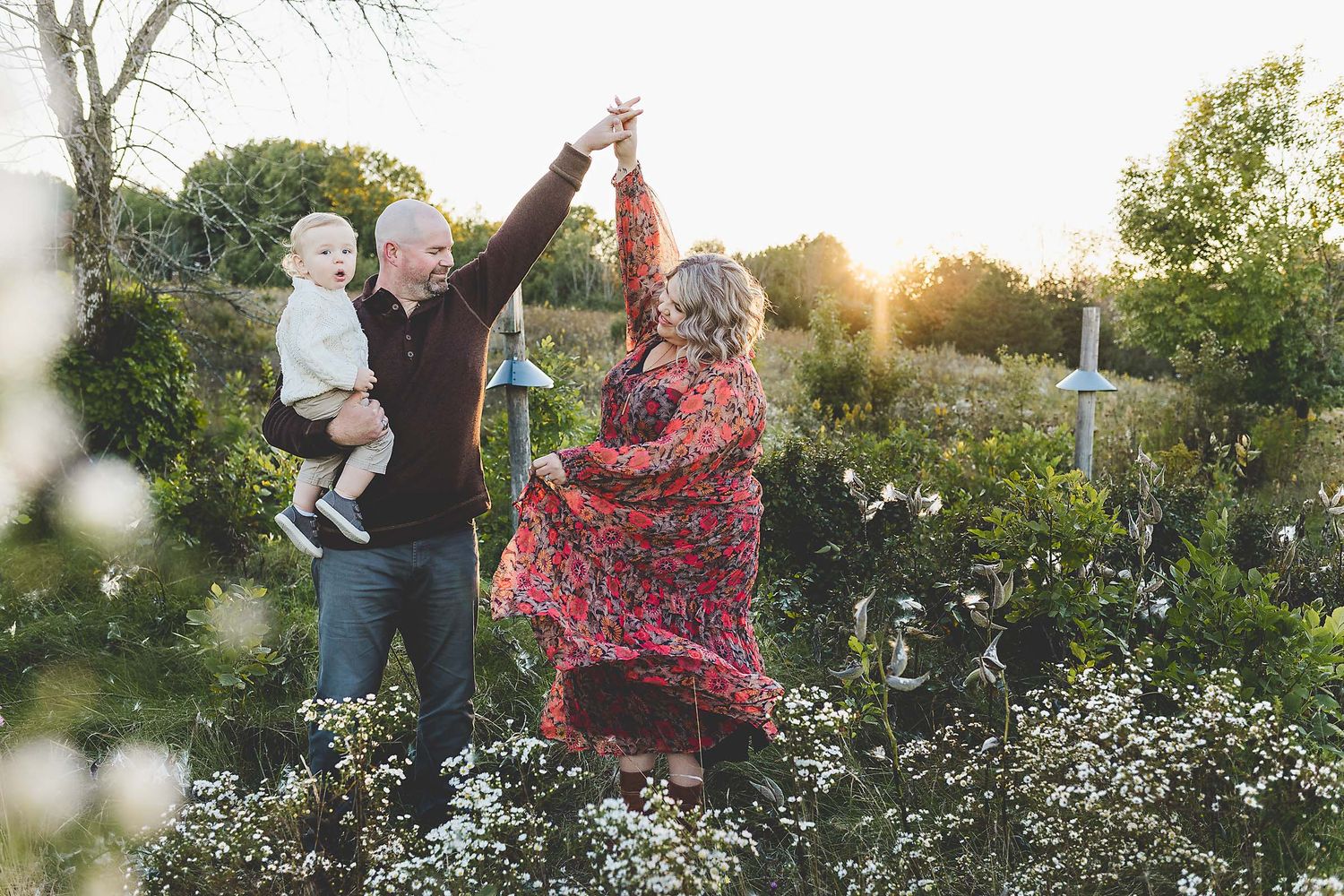 Family photos dancing in a field of flowers with oconomowoc wi photographer.