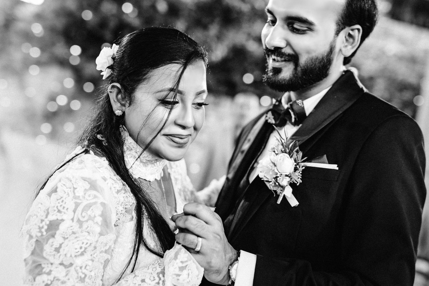 Black and white capture of a romantic dance moment at an elegant wedding reception.