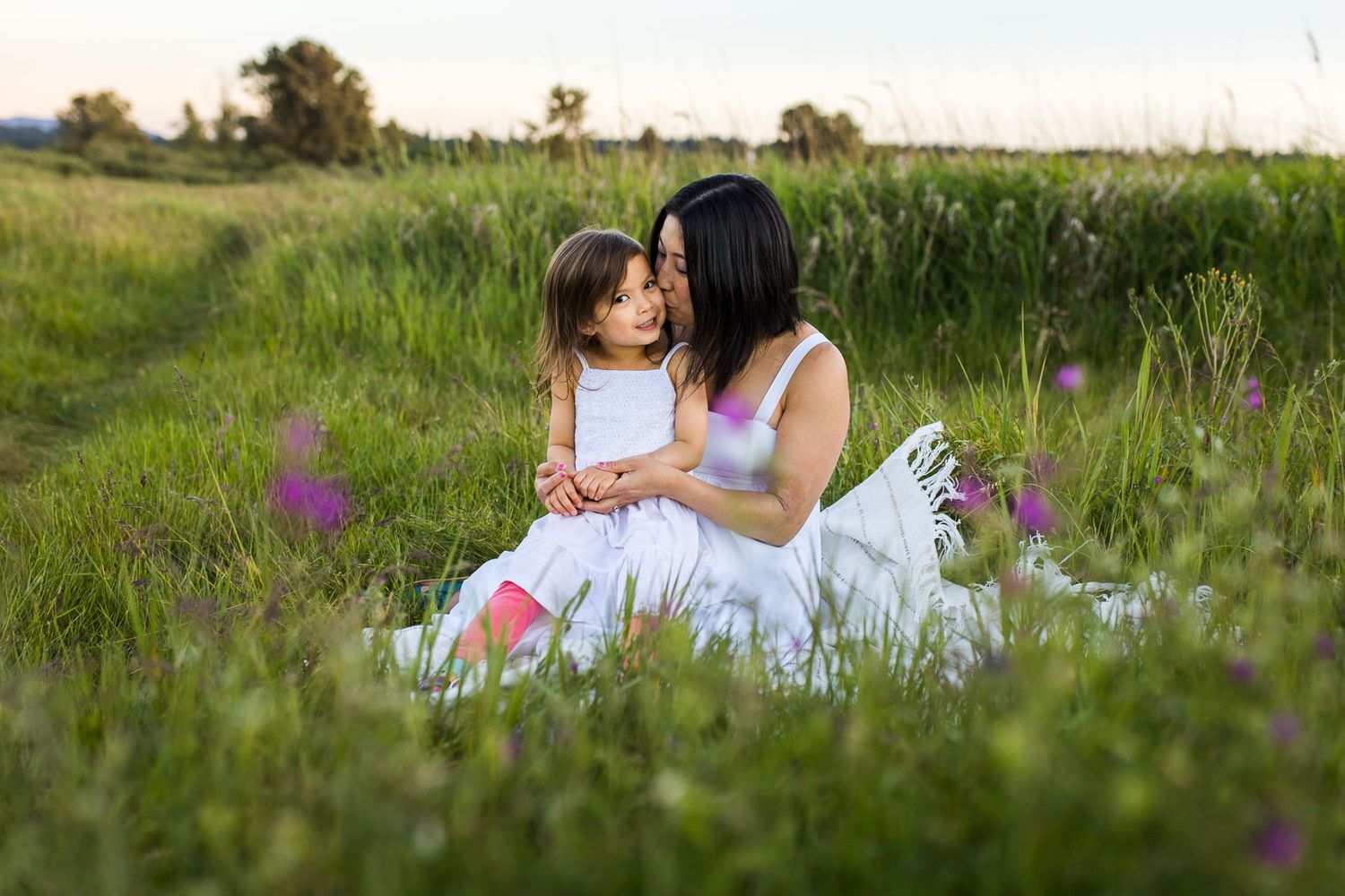 Mother daughter sitting on a blanket in Redmond