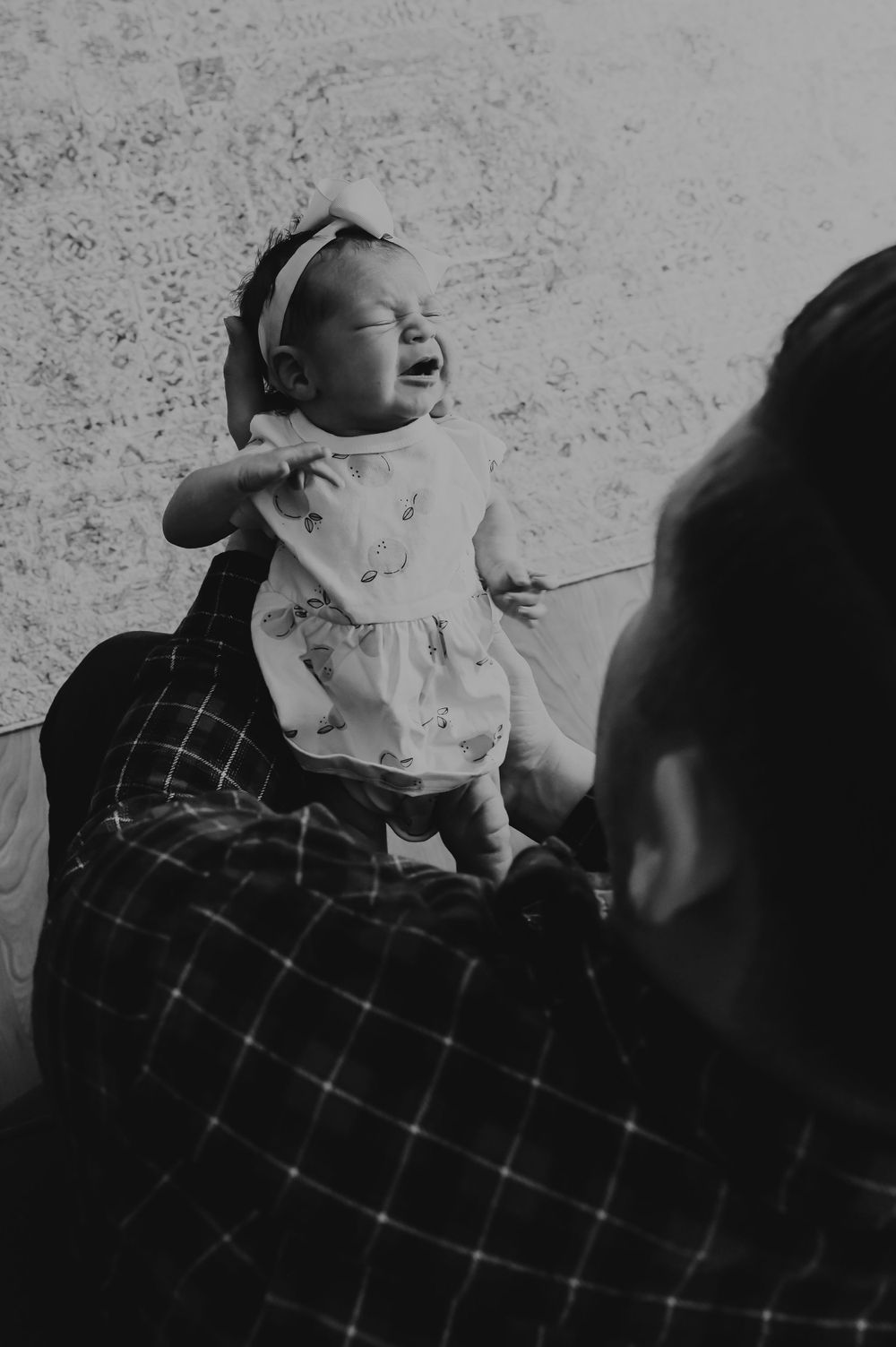 Black and white series showing joyful expressions during family playtime.
