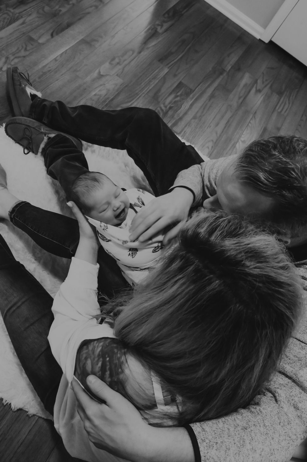 Black and white photo series showing tender moments of affection and connection between people lying down.
