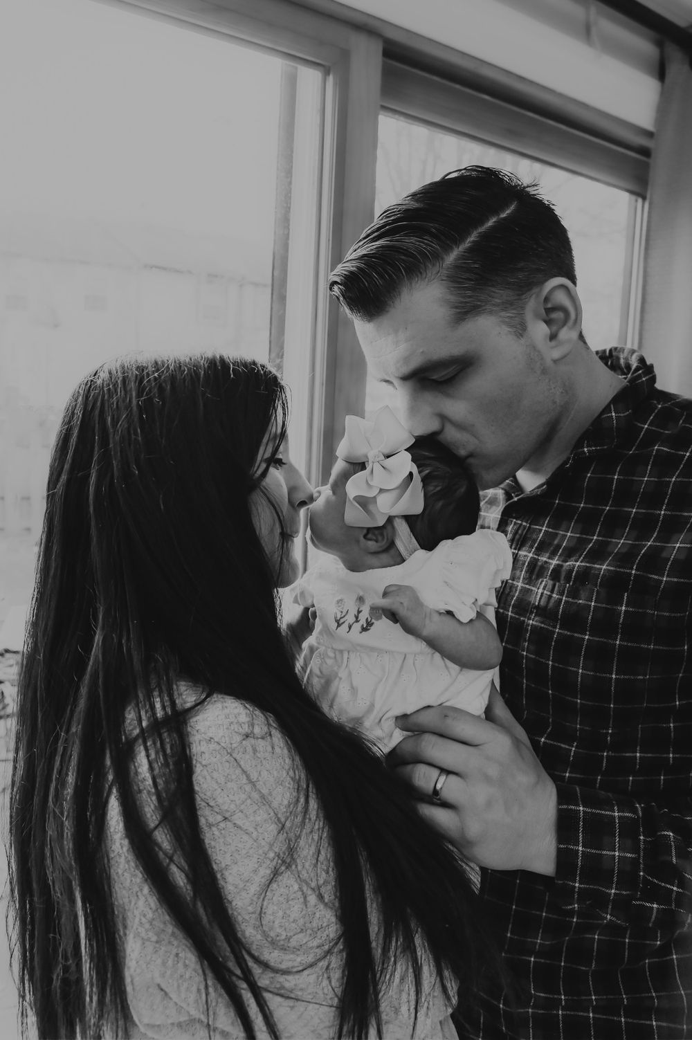 Black and white series showing tender moments with newborn baby.