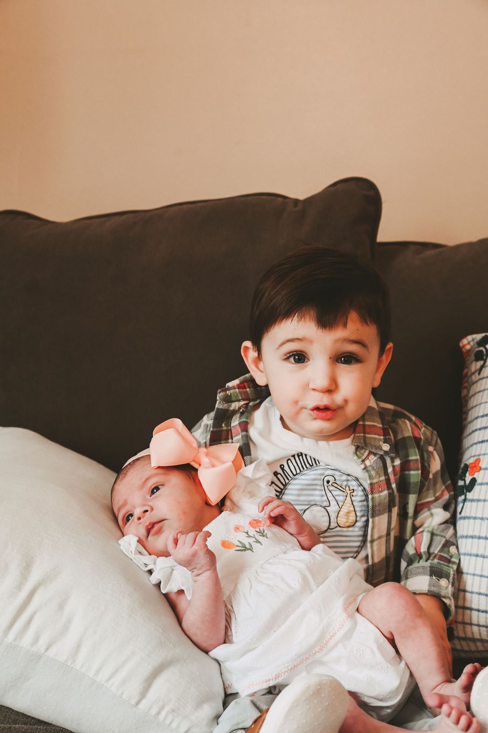 Candid moments of family bonding with young children on couch at home.