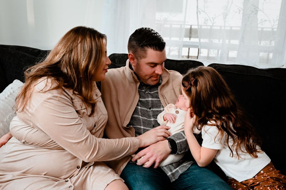 Intimate family moments captured indoors in soft natural light.