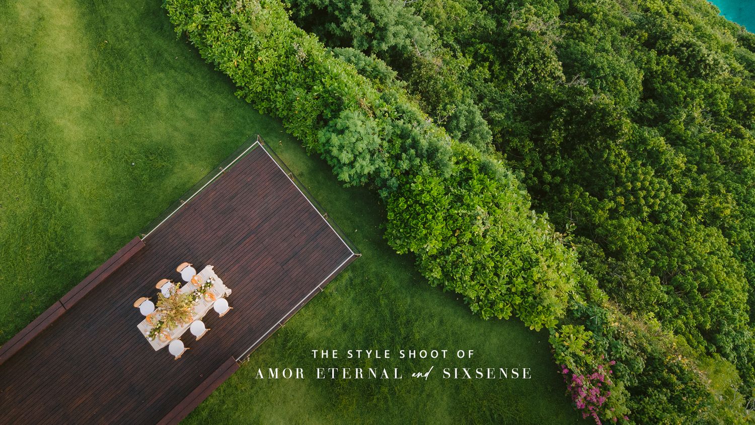 Aerial view of a wooden deck surrounded by lush green landscape.