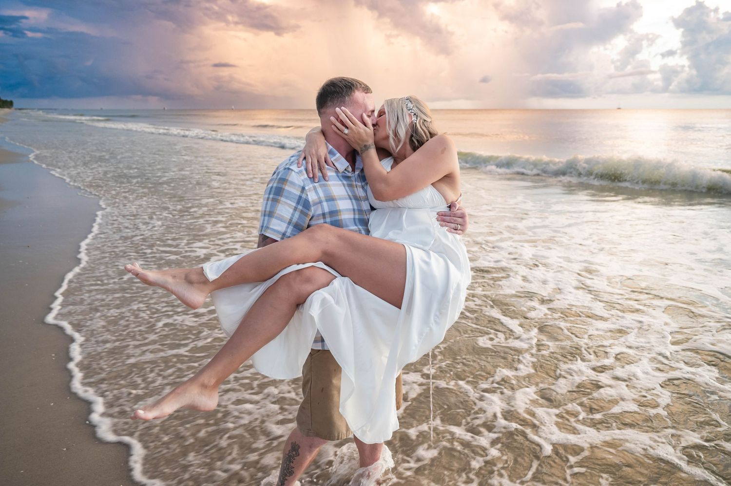 Romantic sunset beach portrait with waves crashing at shore.