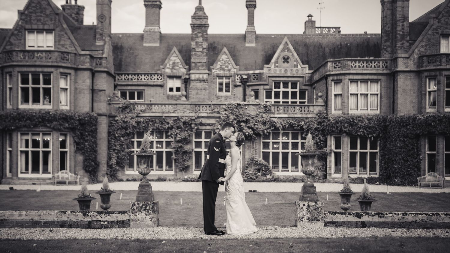 bride and groom kissing in front of holmewood hall