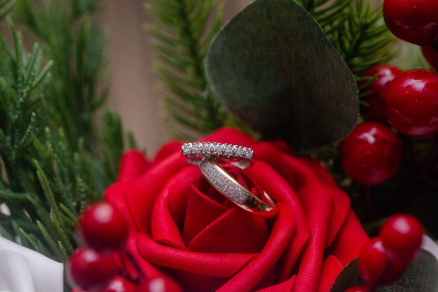 Red roses and evergreen branches create festive holiday decor arrangement.