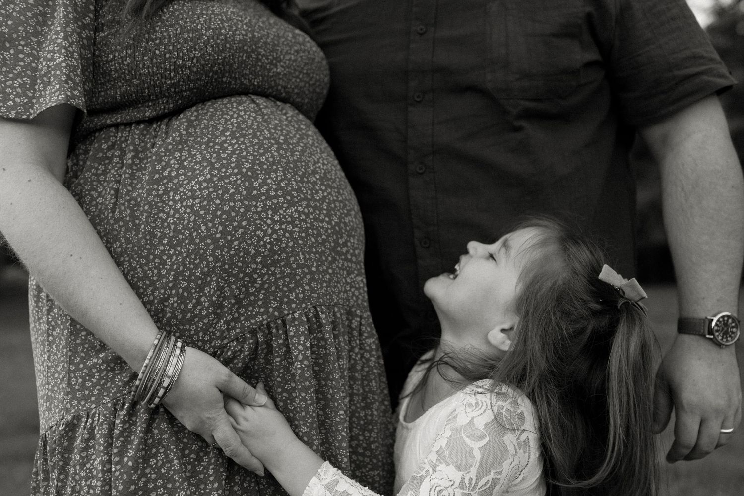 Candid family portrait in Joplin, Missouri captured in natural light by Modern Moods Imagery, showing genuine connection and movement.