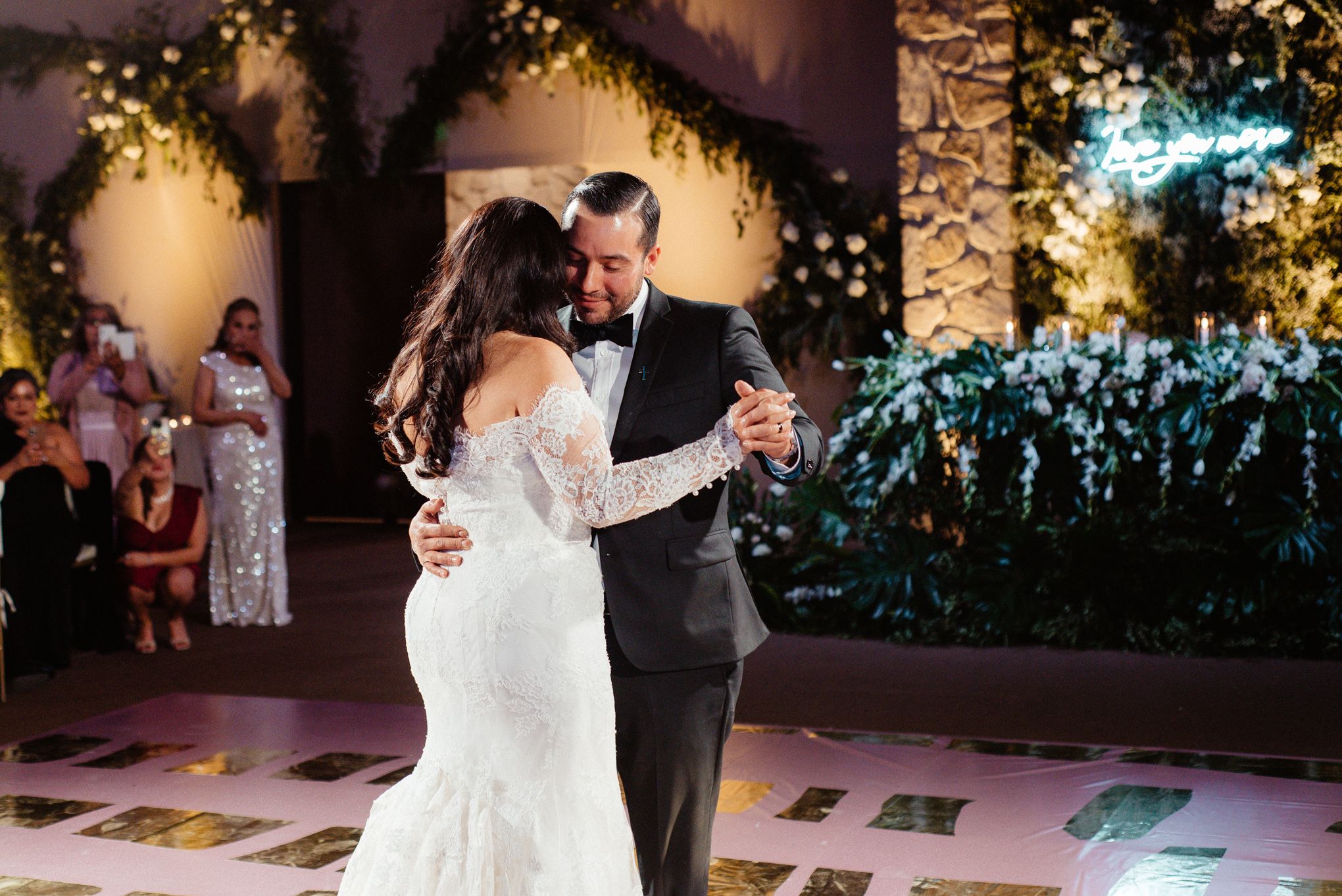 Wedding reception dance floor with string lights and festive atmosphere.