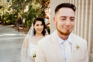 Classic wedding portraits taken on steps with white columns and natural lighting.