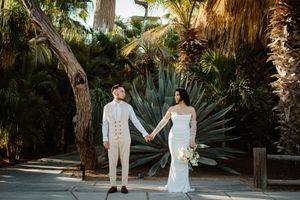 Tropical garden wedding portraits with palm trees and natural scenery.