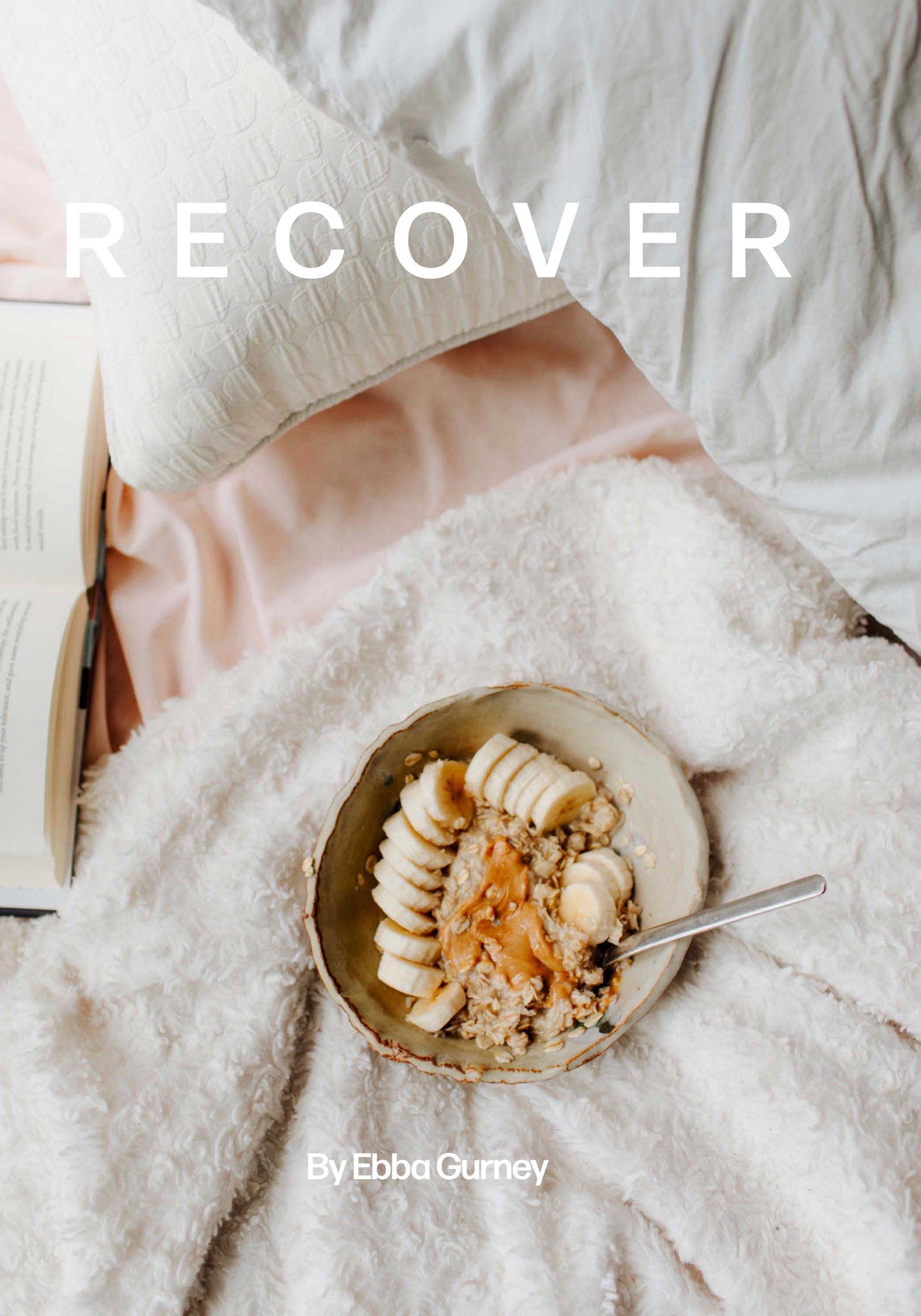 A smoothie bowl with sliced bananas and granola on white bedding with text that says RECOVER.