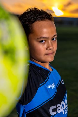 Close up portrait of youth athlete in blue Capelli sports jersey.