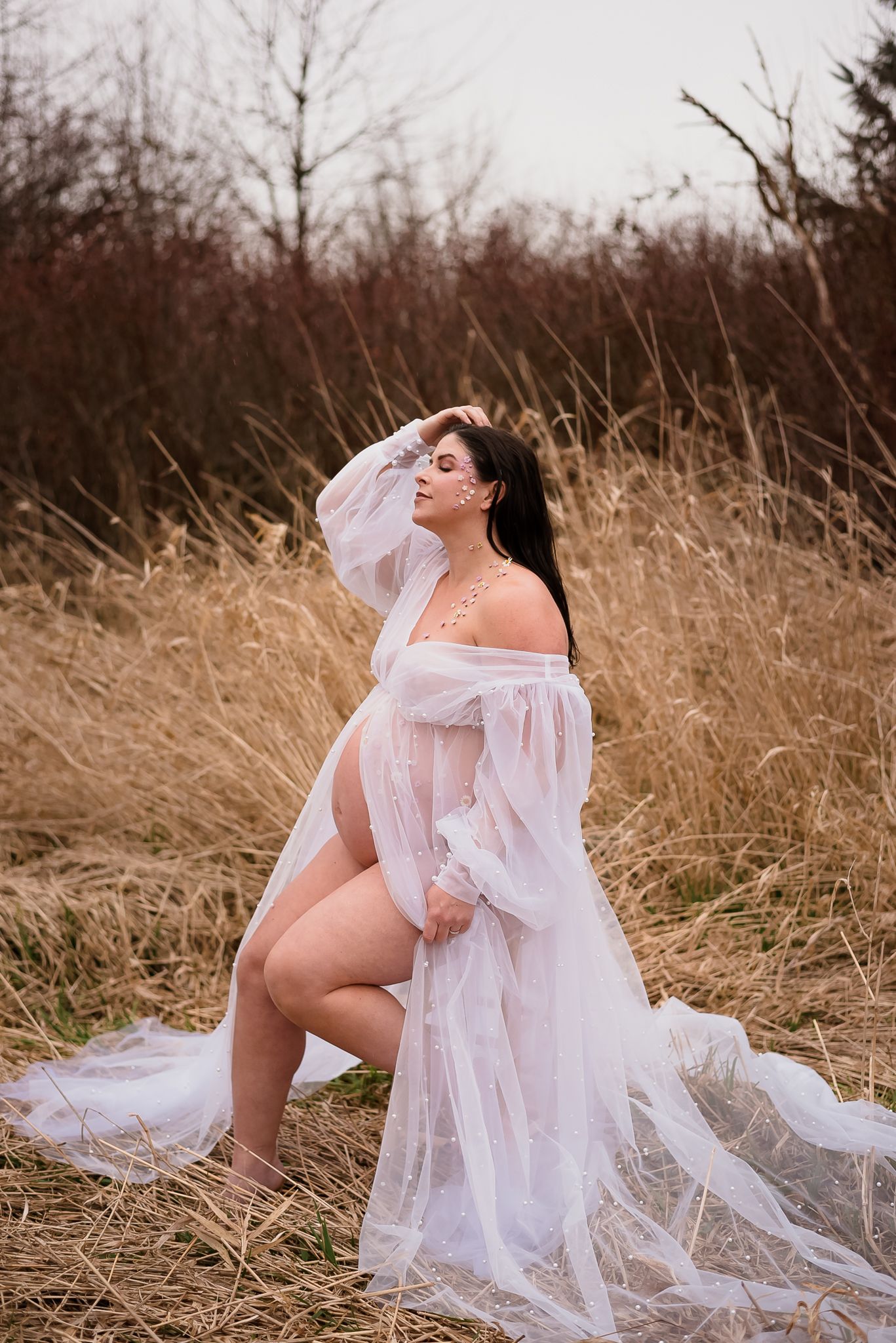 Pregnant woman closes her eyes in a stunning white dress during a photo shoot in Surrey, BC.