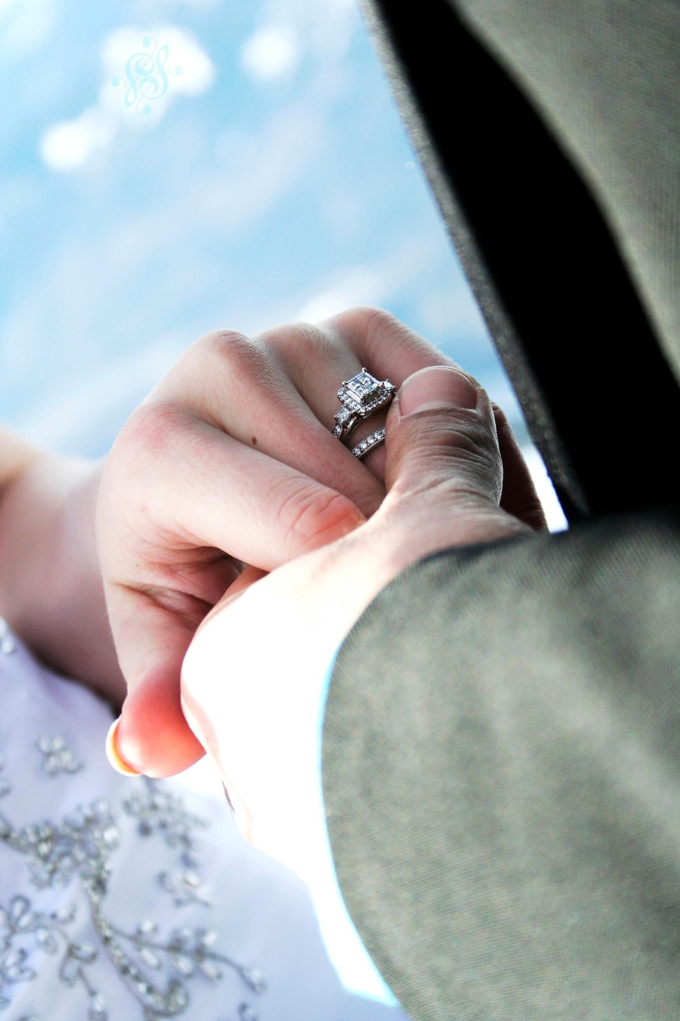 Close-up of diamond engagement ring with bokeh background.