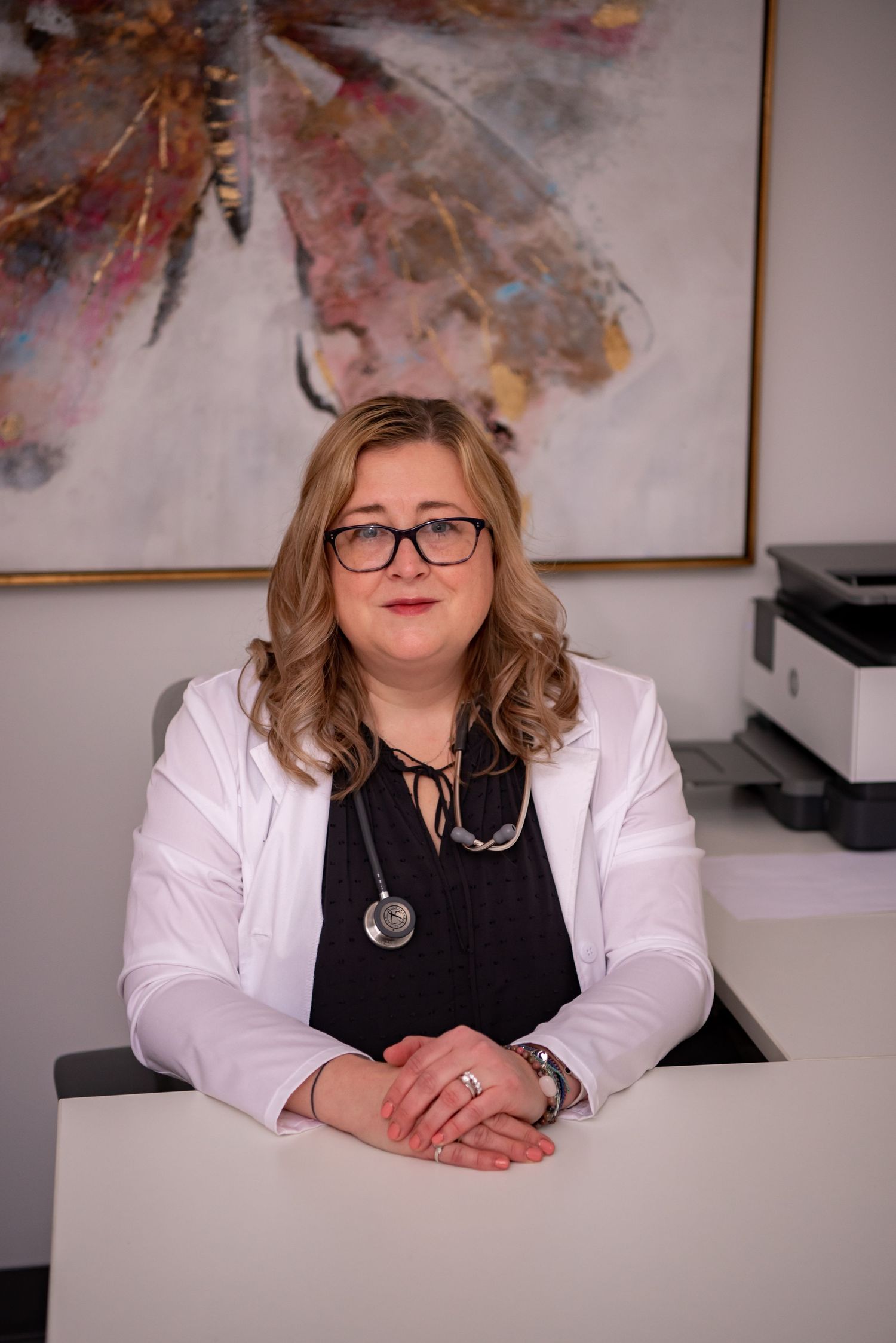 woman doctor sitting at desk with white coat and stethoscope rebecca byard