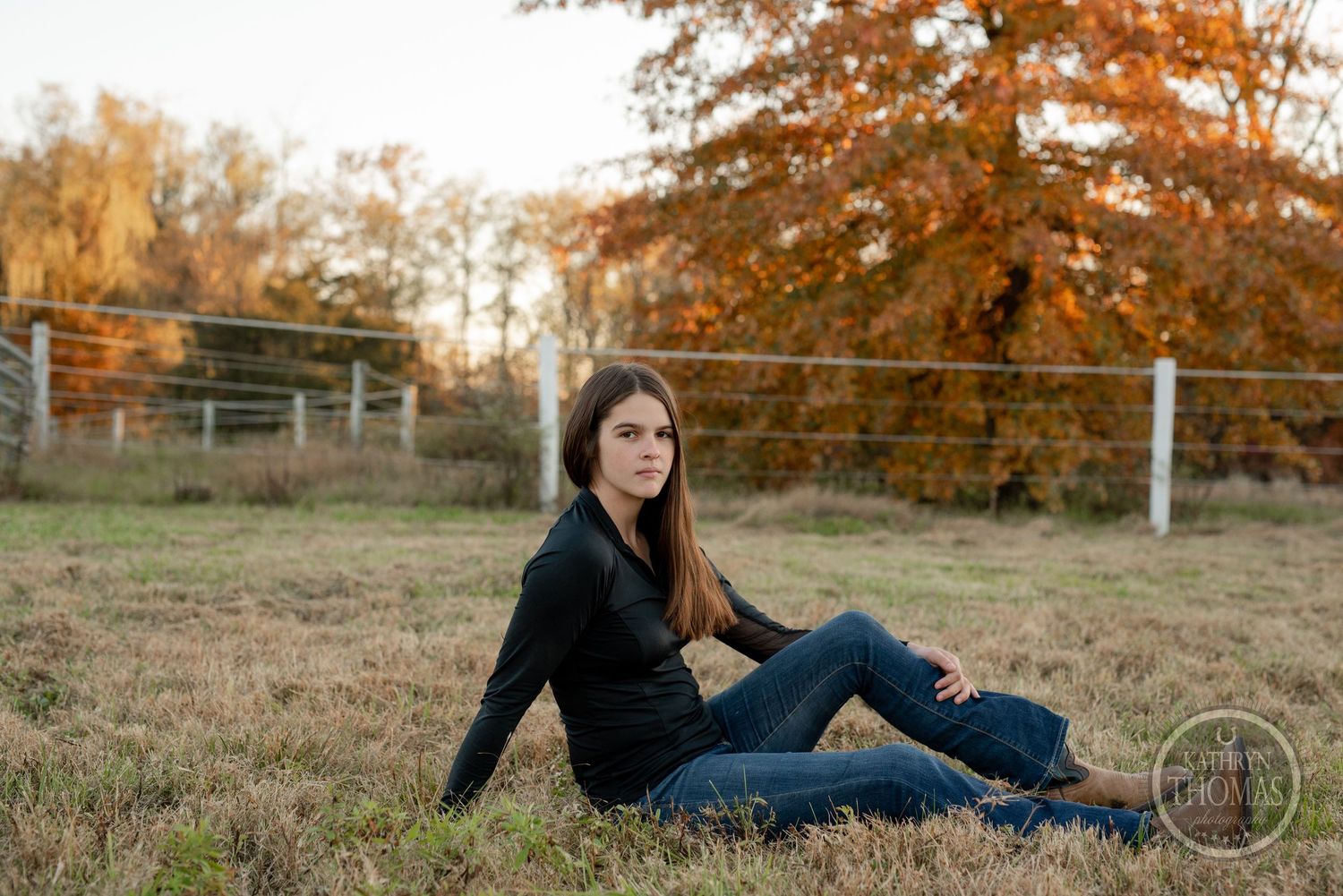 Casual outdoor photo session in a rustic autumn setting with golden light.