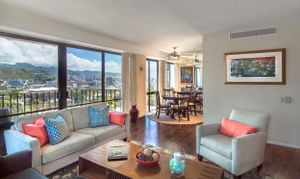Luxury living room with mountain views through large windows and modern coastal decor. Realestate Photography