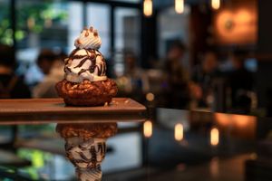 Decadent chocolate dessert with whipped cream and drizzle photographed with artistic bokeh effect. Food Photography