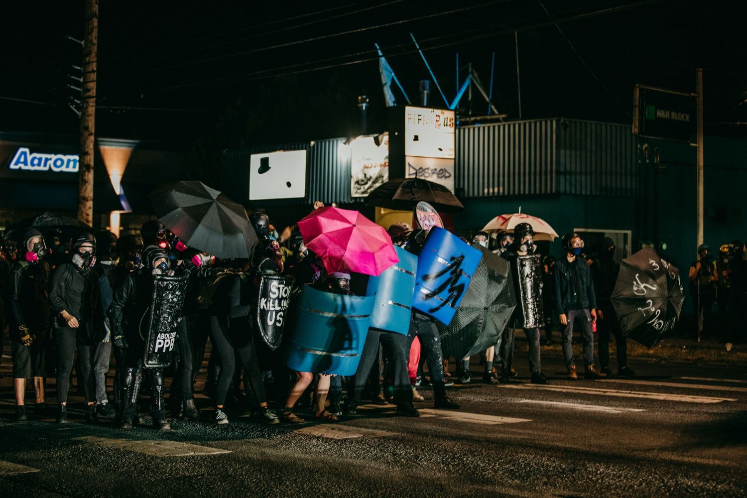 protesters hold the front line with barrel shields and umbrellas portland oregon BLM photojournalism