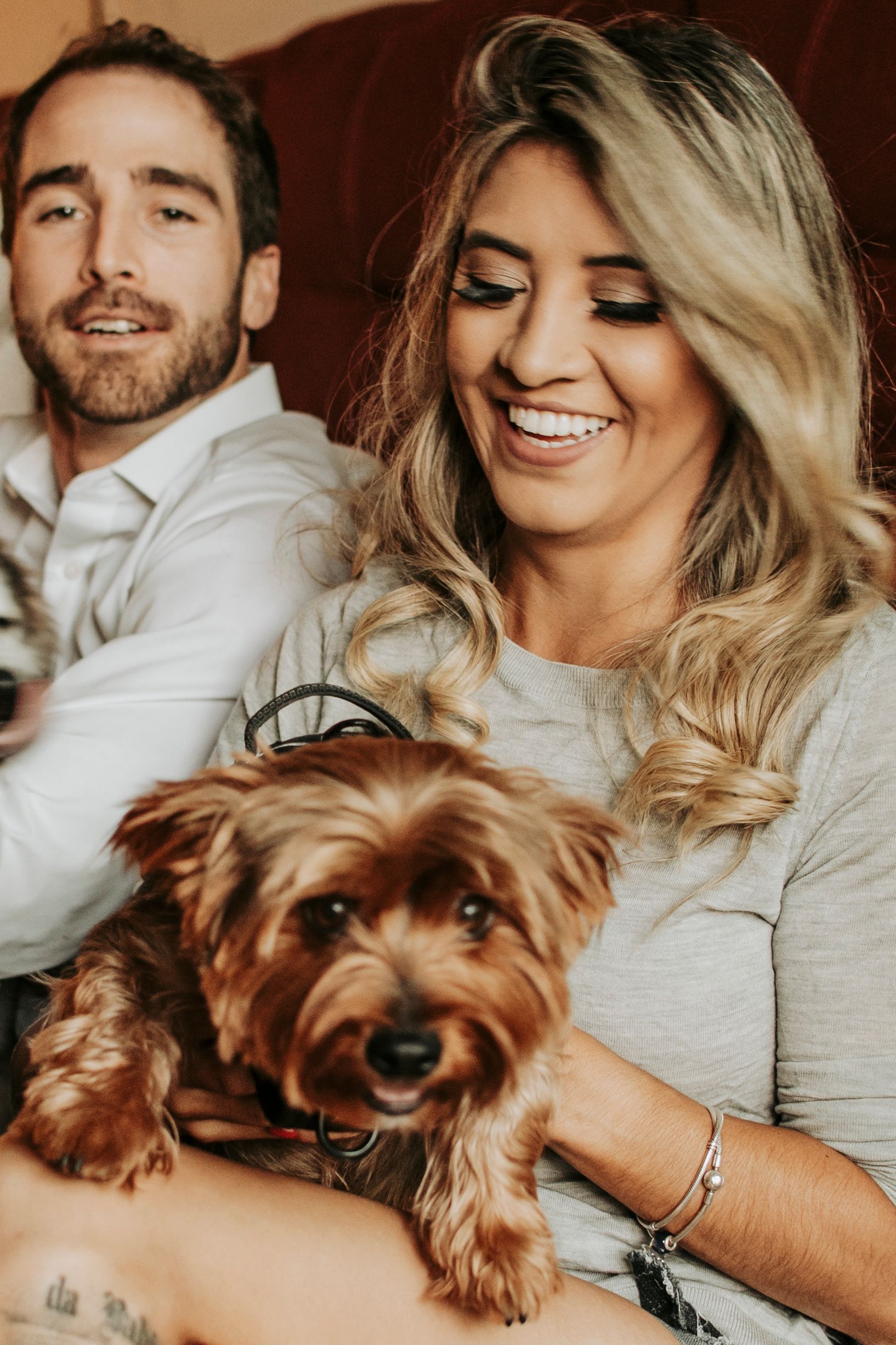 Casual portrait of a couple relaxing at home with their Yorkshire Terrier dog.