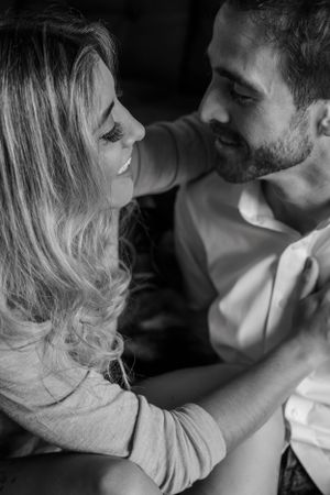Black and white photo capturing intimate romantic moment between couple.
