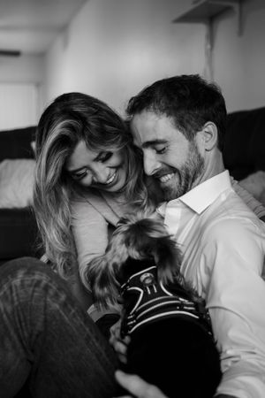 Black and white photo of loving couple sharing playful moments together.