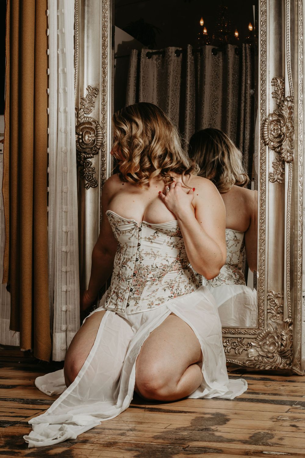 Artistic portrait against ornate mirror with classic interior decor.