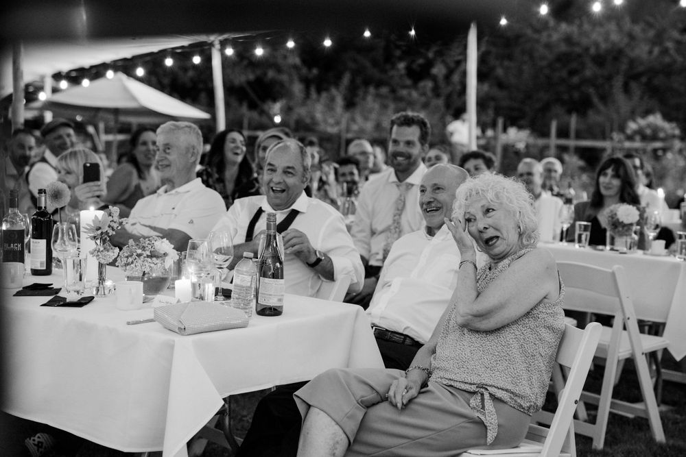 wedding guests laugh at the evening reception in Victoria