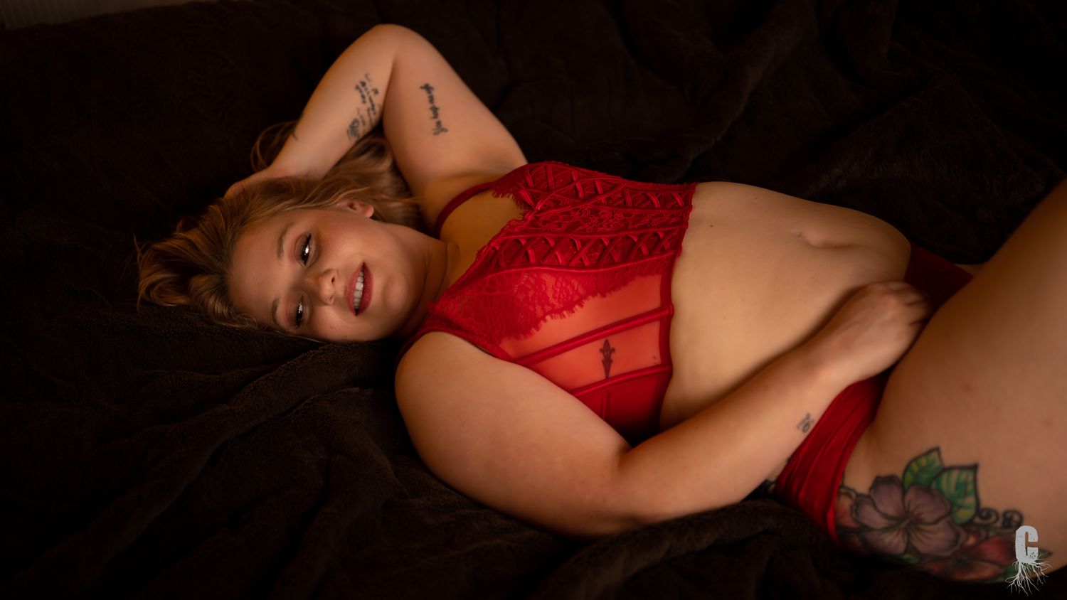 A boudoir model stretched out on a bed