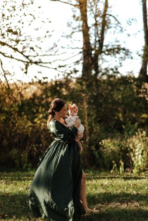 mom walking holding baby