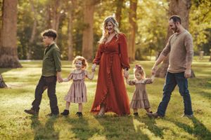 a family walks hand in hand in a line
