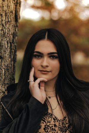 headshot, senior girl with her hand on her cheek