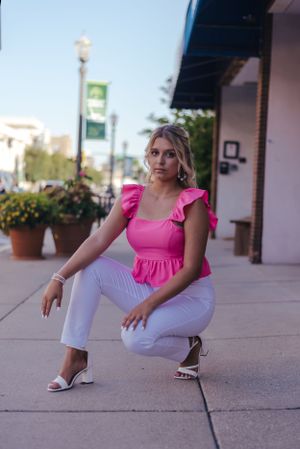 a young woman posing on a city street